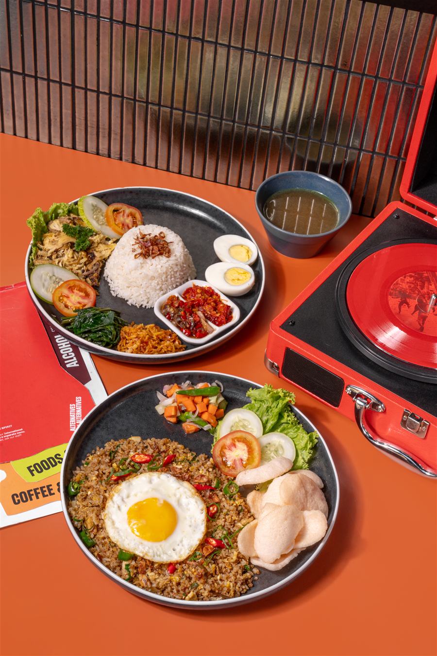 Nasi goreng betutu and nasi komplit betutu plated side by side