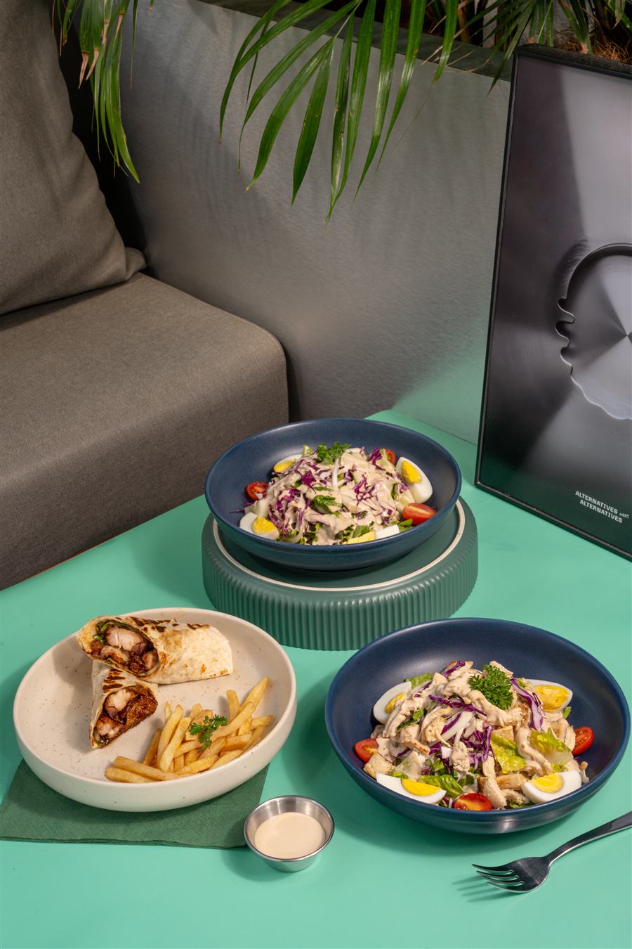 Teriyaki wrap with fries alongside two chicken salad bowls