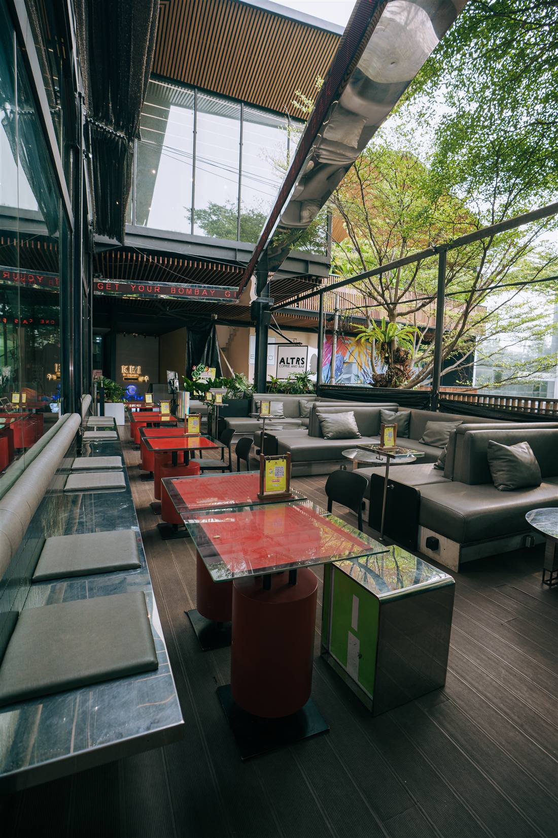 Lounge sofas beneath the ALTRS Coffee and Bar sign