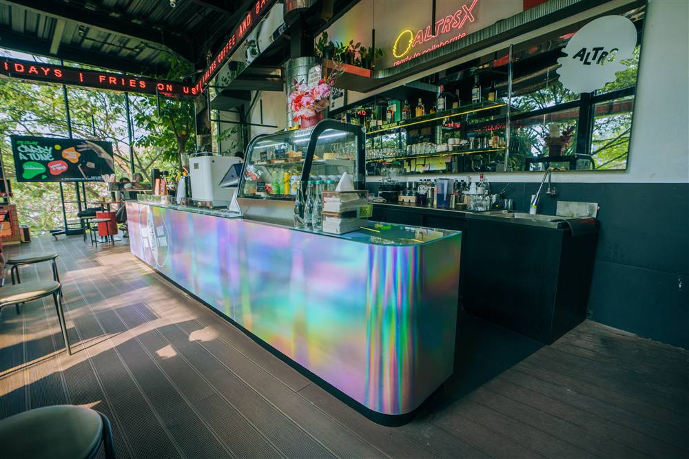 Bar counter with the holographic front and neon signage at ALTRS