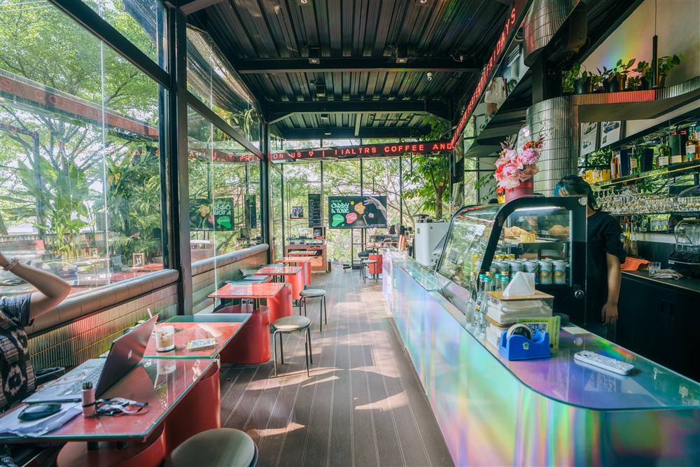 Terrace seating beside the glowing bar counter at ALTRS